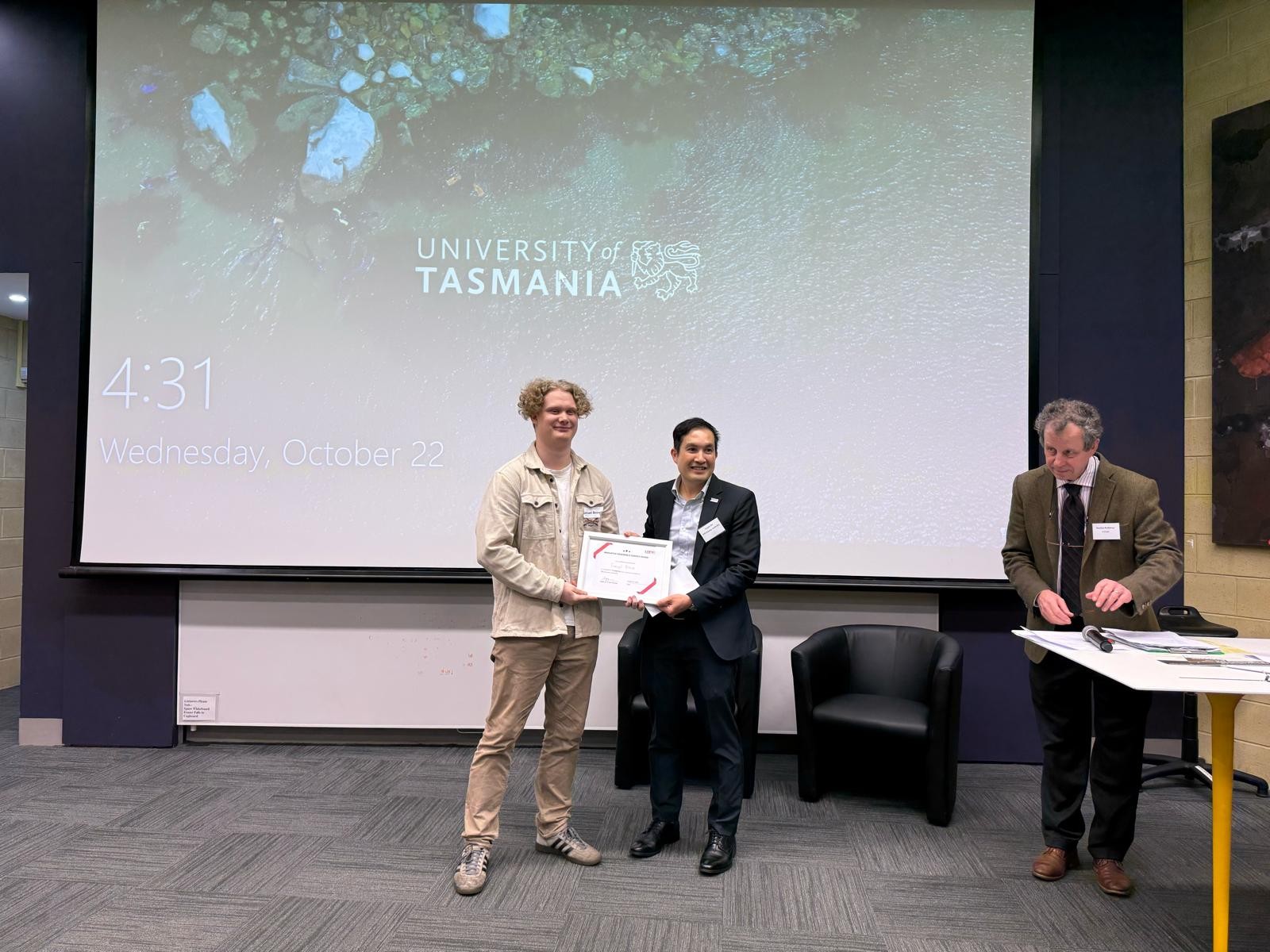 Logan Ho judges student projects at the Innovative Renewable Energy Prize