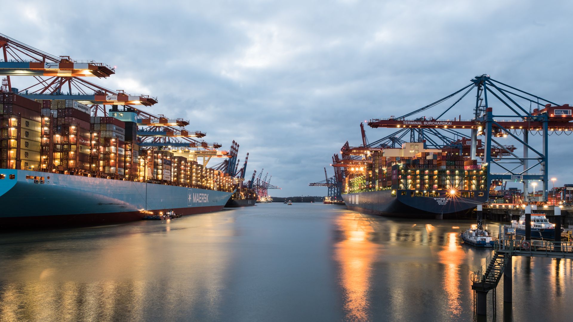 Container ships being loaded by gantry cranes at an international shipping port